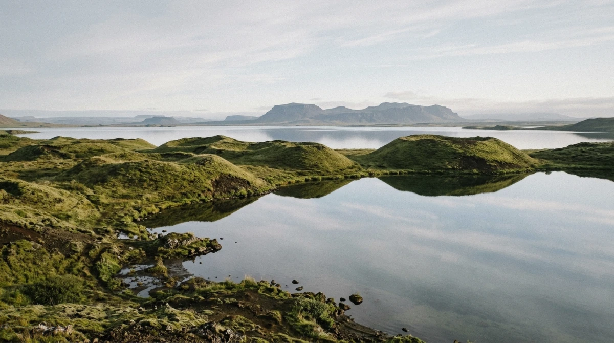 Pseudo-craters and still water on the south shore of Lake Myvatn on a day tour from Akureyri